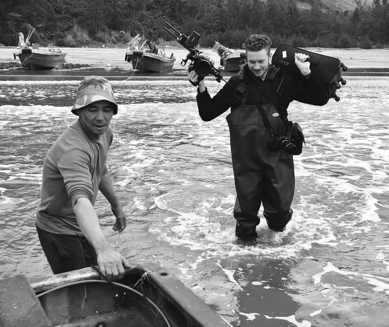 Thomas Gilbert carrying camera equipment during documentary production in Taishan