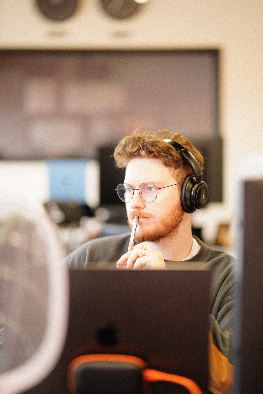 Thomas Gilbert working at a computer in a post-production studio